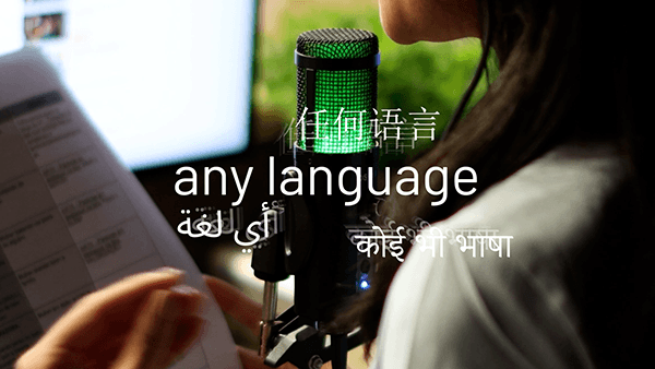 A narrator recording voice-over, captioned in English, Chinese, Arabic and Hindi